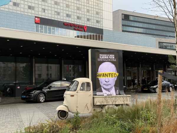 A billboard calling for the arrest of Russian leader Vladimir Putin is placed outside the venue hosting the 24th session